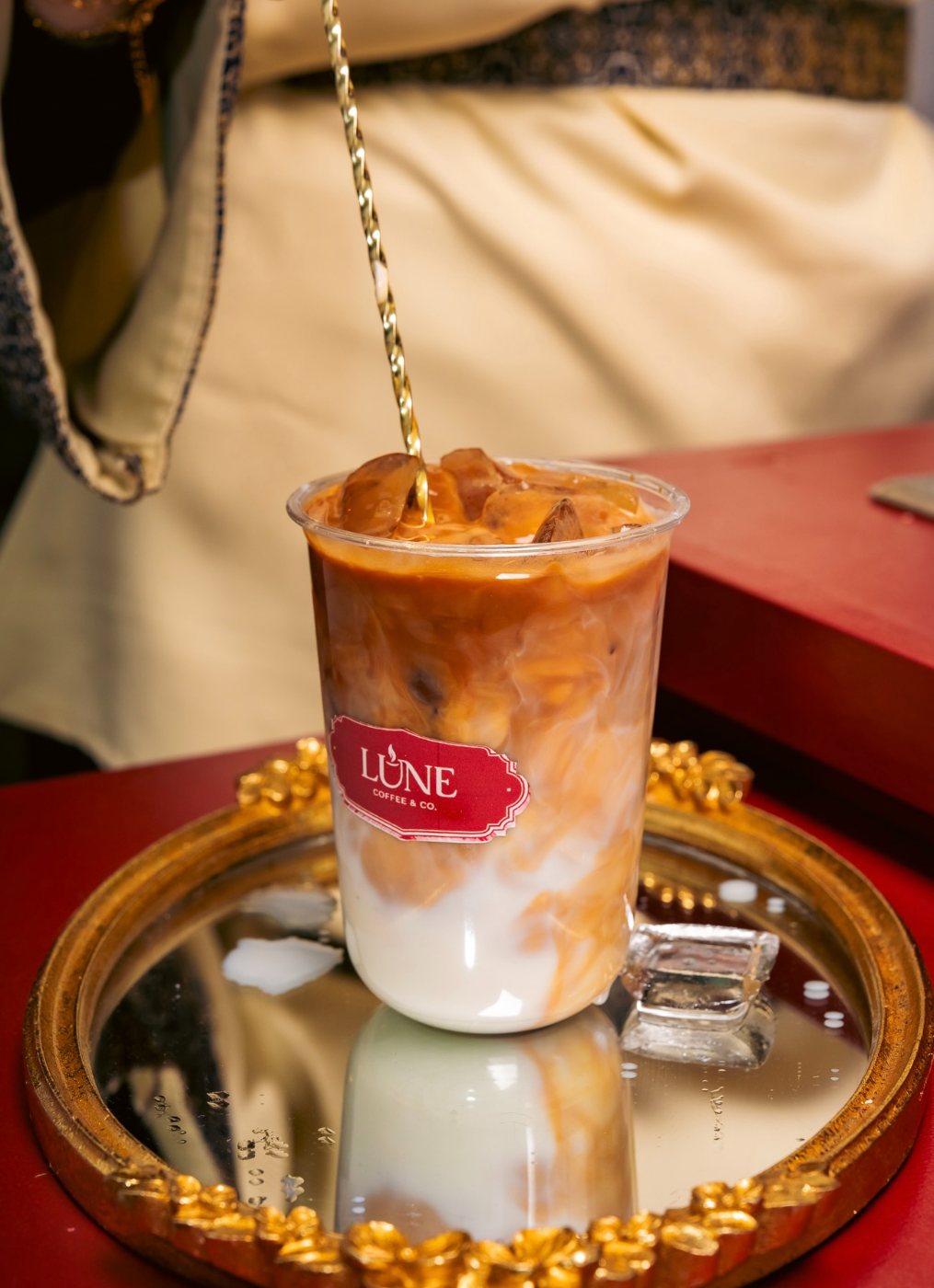 Iced latte with a gold spoon